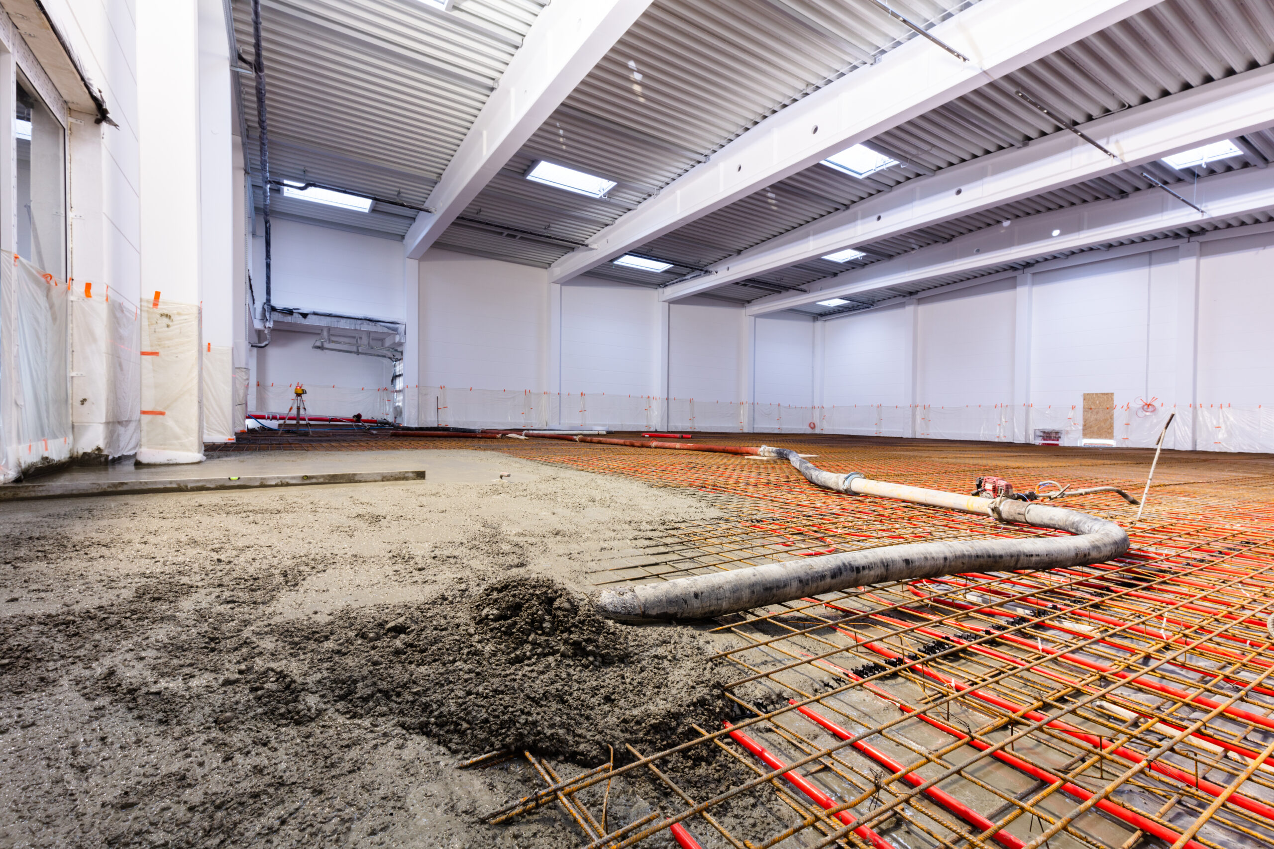 Concrete screed on floor heating in a new warehouse and office building. Interior finishing industry.